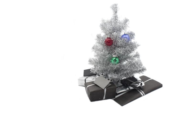 a small silver christmas tree, decorations and presents at the base