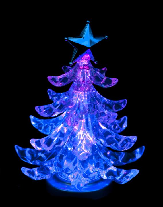 a glowing christmas tree ornament illuminated in blue and pink colors