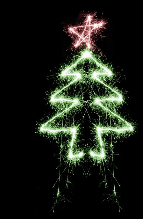 a green and red coloured christmas tree and star shape drawn with a sparkler
