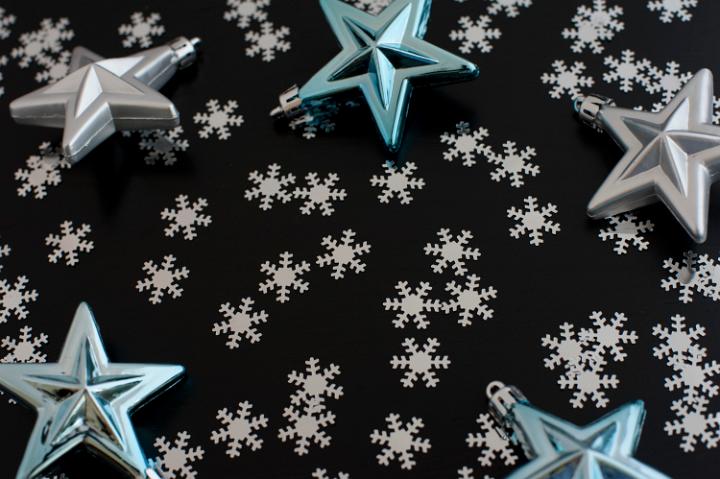 Christmas star background with scattered winter snowflakes forming copyspace for your greeting or message
