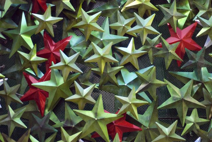 an assortment of festive star shaped decorations in metallic green and red