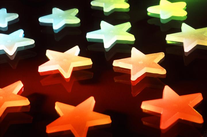 a background photo featuring red green and blue illuminated stars on a black backdrop