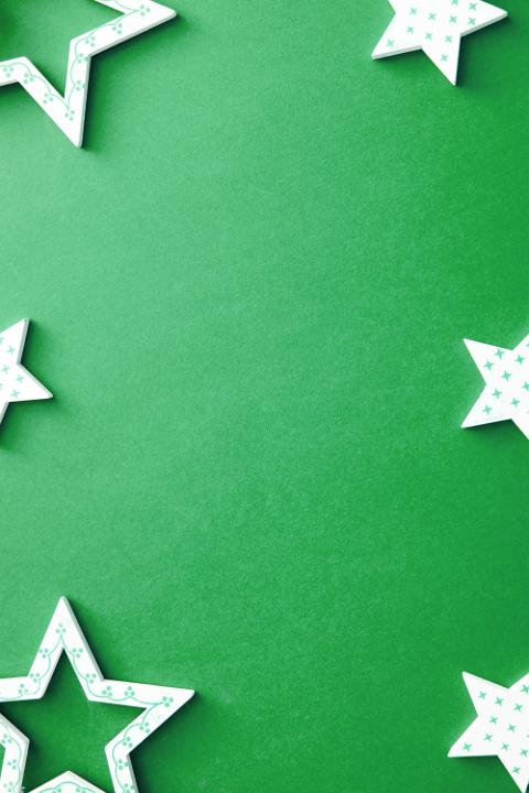 Decorative polka dot star border on green with assorted shapes around central copy space for your Christmas greeting