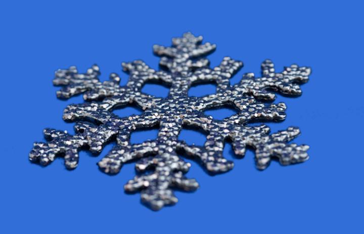 a christmas snowflake decoration on a blue background