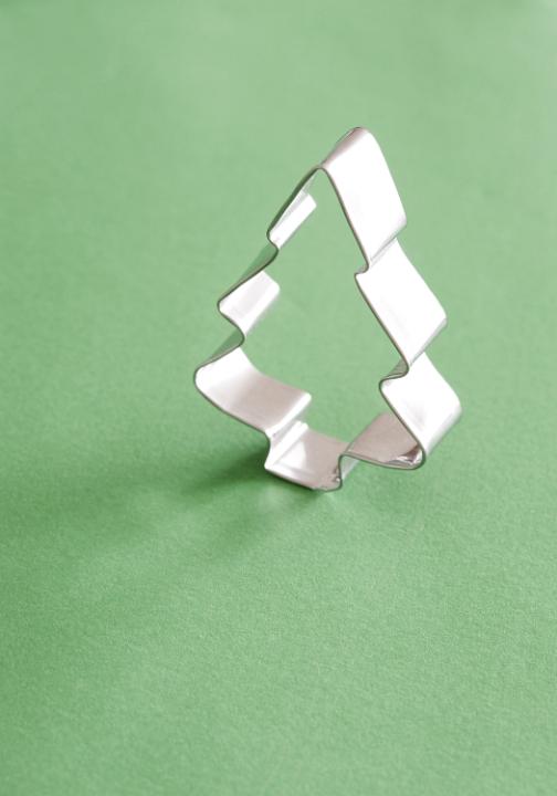 Close-up of Christmas tree cookie cutter on green table