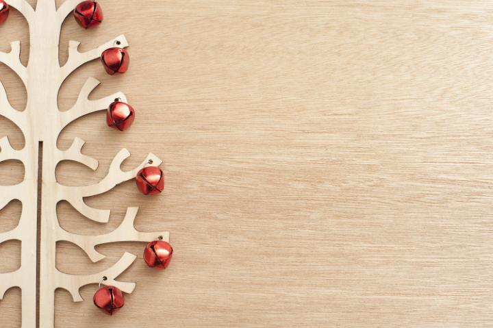 Close-up of handmade wooden tree decorated with red Christmas balls