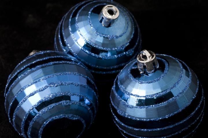 close up on three blue colored chirstmas baubles