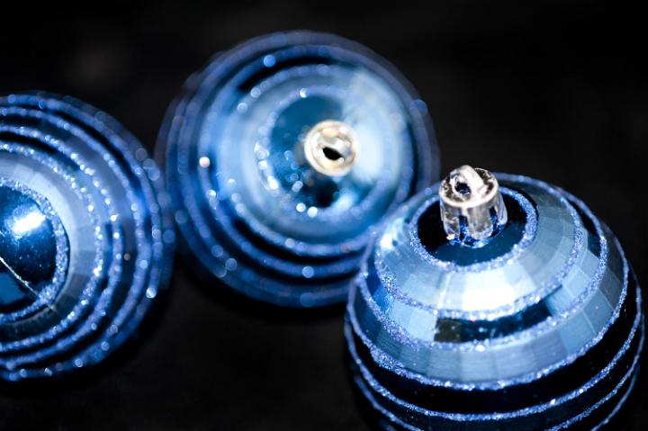 close up on three glitter covered christmas baubles