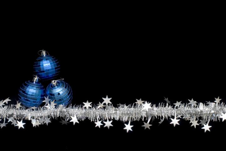a line of christmas tinsel and blue festive ornaments