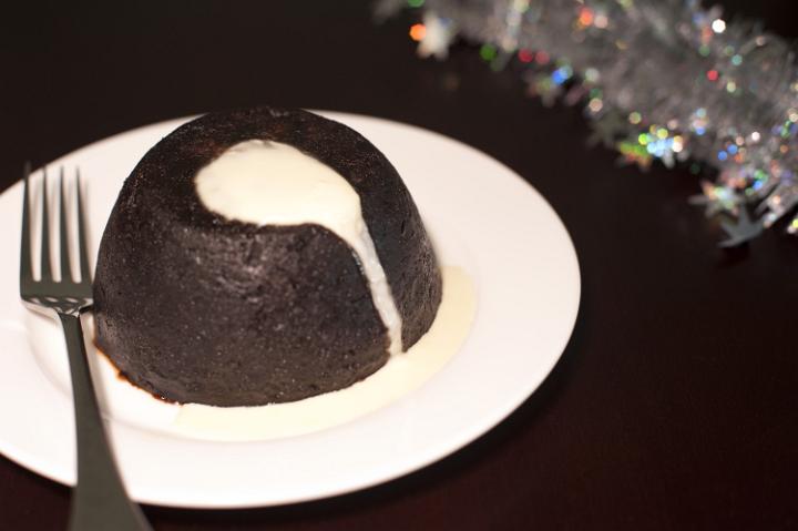 a christmas plumb pudding with brandy butter sauce