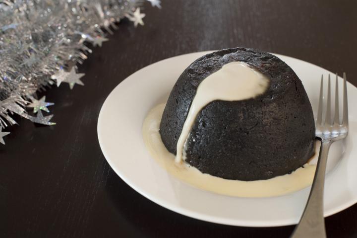 a christmas fruit pudding with brandy sauce