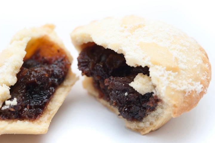 Close up detail of the rich fruity filling in a Christmas mince pie which has been broken open , focus to the filling