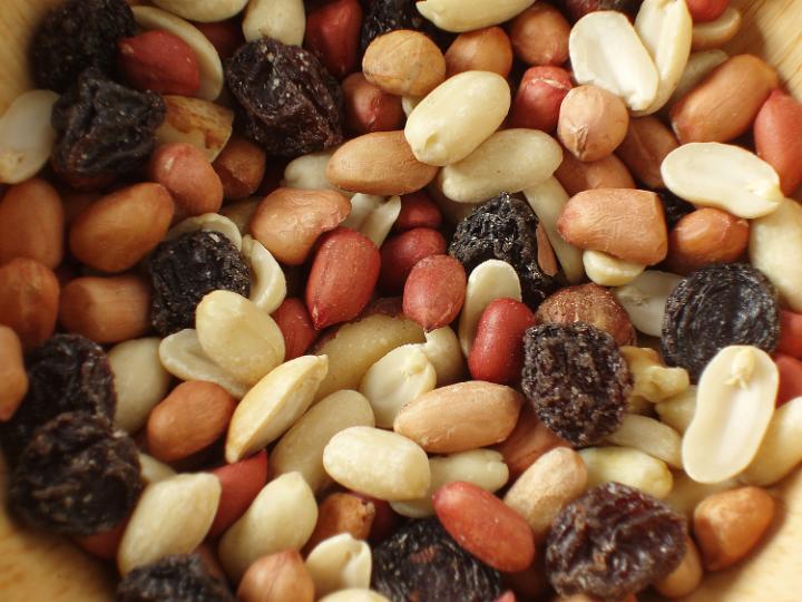 christmas snack food, close up on a bowl of rasins and mixed nuts