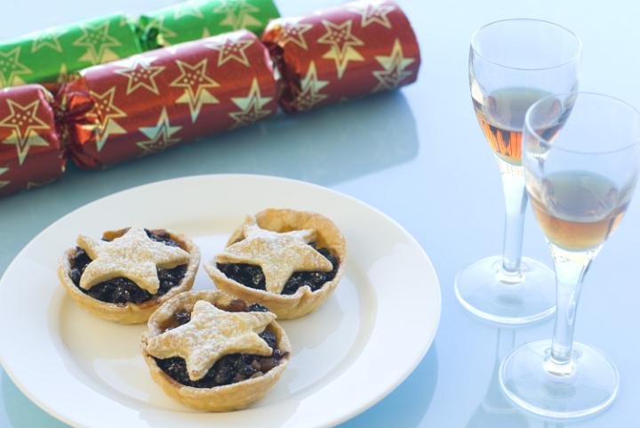 a plate of christmas mince pies with star shaped pastry tops