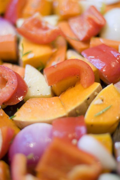 an assortment of vegetables for roasting, pumpkin, onion and capscium bell pepper