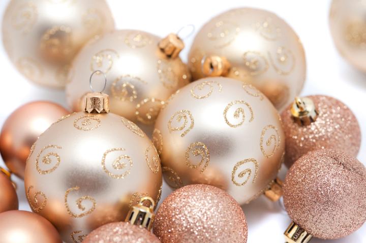 a background of gold coloured christmas baubles of various sizes