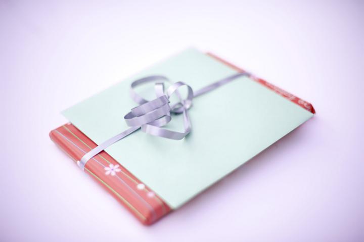 a christmas present and greetings card bundled with a ribbon and bow
