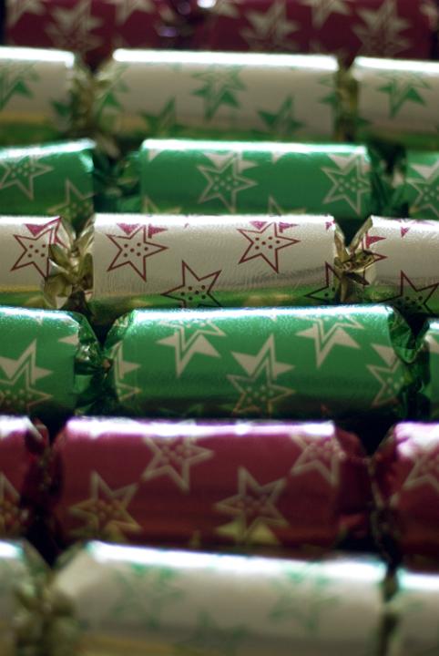 a row of colourful christmas crackers pictured with a narrow depth of field