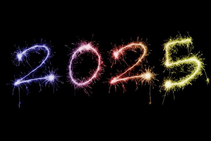 2025 colorful sparkling festive New Year sparkler background over black with copy space for your holiday greeting