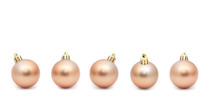 Line of five Gold Christmas balls on a white background with copyspace
