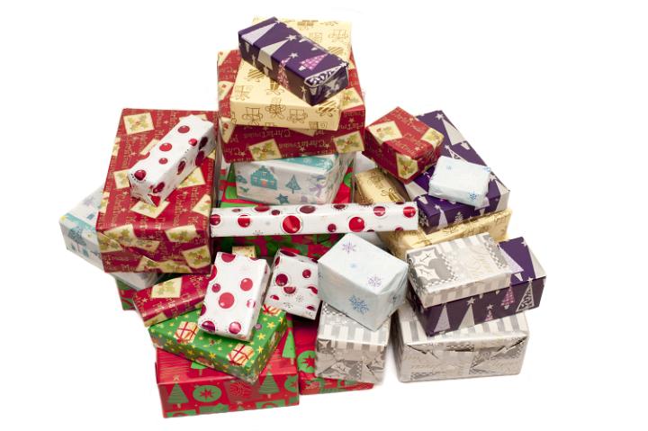 Colorful pile of Christmas gifts in assorted seasonal wrapping paper isolated on a white background with copy space for your greeting, high angle view