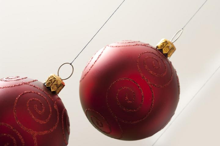 Two red Christmas balls hanging  on white background