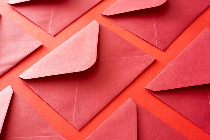 Close up shot of an array of red invitational envelopes