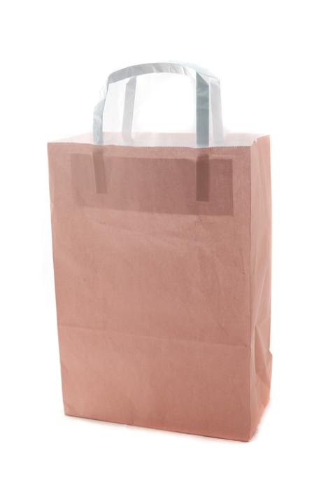 Brown paper gift or carrier bag suitable to be recycled with handles and copy space for branding isolated on white