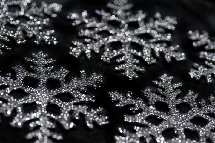 a background photo of christmas snowflake ornaments on a black background