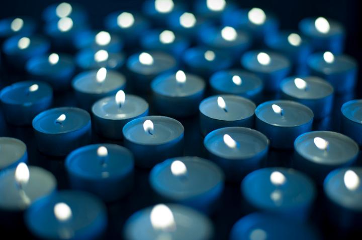 Background of burning blue candles to celebrate Christmas, New Year or an anniversary