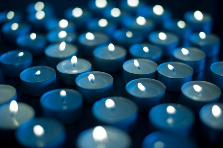 Background of burning blue candles to celebrate Christmas, New Year or an anniversary