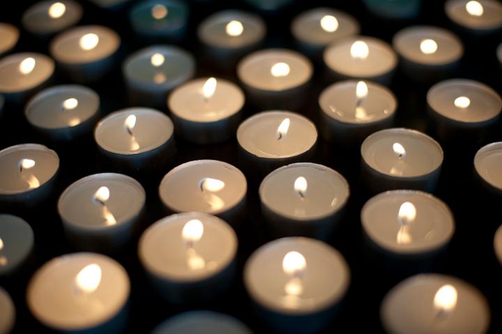 a background image of many burning christmas tealight candles