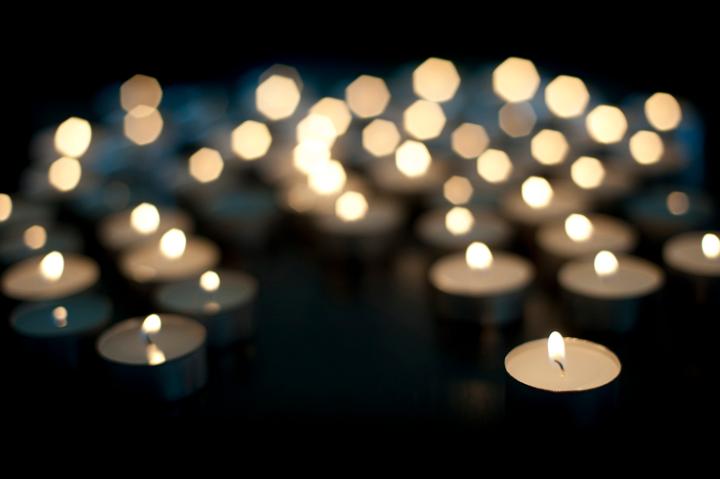 background image of out of focus christmas trealight candles with space of text